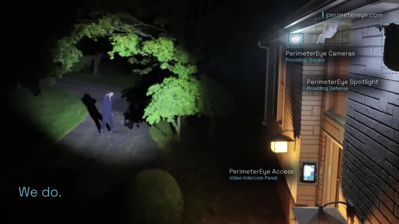 The searchlight catching a person on the dark driveway as they raise their hands against the light, with the PerimeterEye cameras, searchlight and Access video intercom labeled