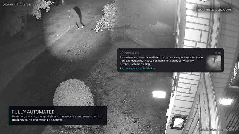 The person turning away from the house while the searchlight beam follows